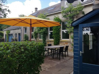 The paved terrace in the corner of the house and the classroom, inviting for a delicious lunch